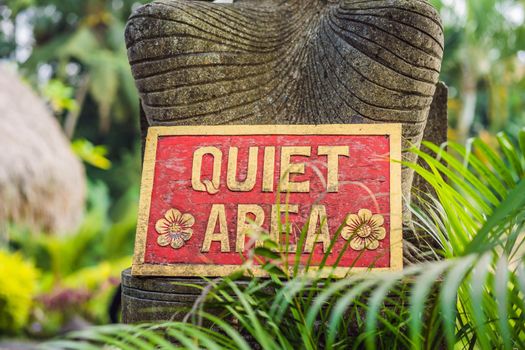 A sign QUIET AREA in a quiet corner of the garden.