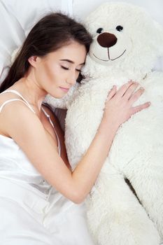 Sleeping girl with a teddy bear