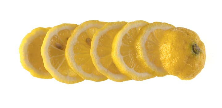 Lemon sliced in wedges and laid out in a row on a white background