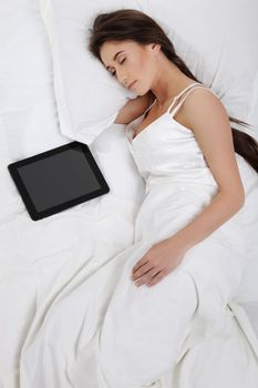 Woman lying in bed with her tablet PC