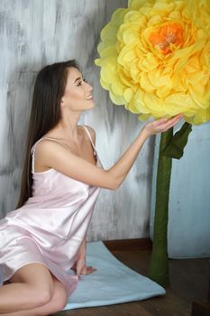 Fashion art photo of beautiful lady with big flower. Home interior. Morning