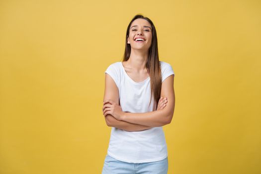 Portrait young beautiful caucasian girl with an white shirt laughing over yellow background