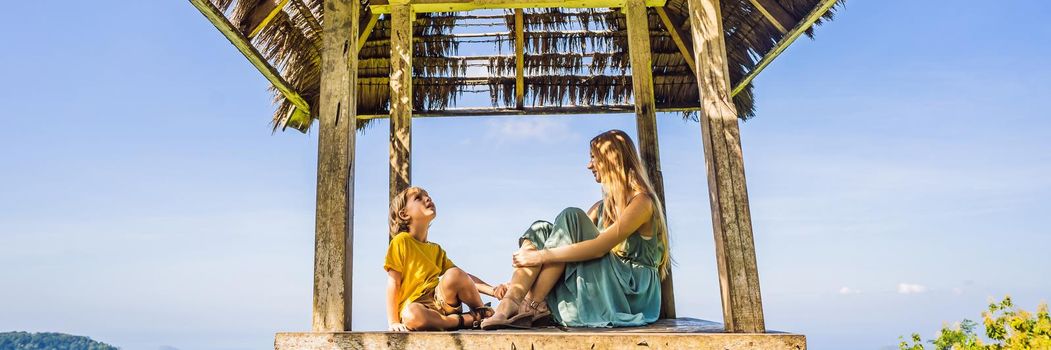 Mom and son in a gazebo in Bali. Traveling with kids concept. Kids Friendly places. BANNER, LONG FORMAT