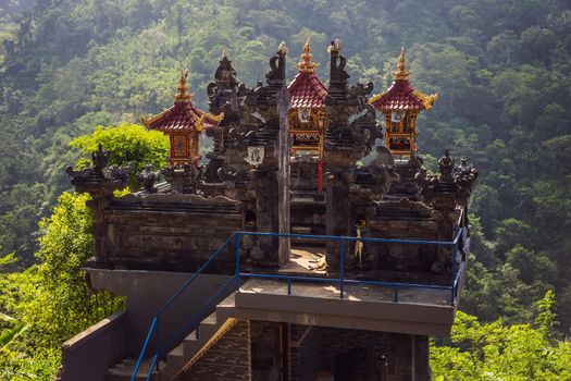 Traditional Balinese houses and temples with panoramic view at jungle, tropical rain forest and mountains.