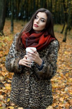 Autumn woman portrait smiling outdoors at the park