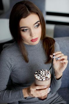 Girl eating chocolate desert brown with white cream