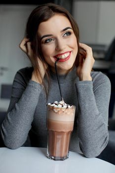 Girl eating chocolate desert brown with white cream