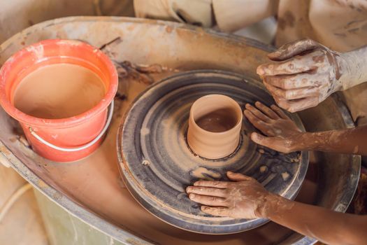 Father and son doing ceramic pot in pottery workshop.