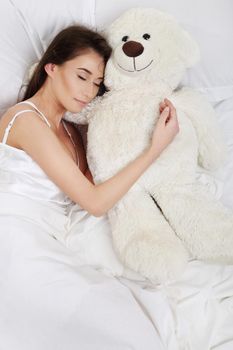 Sleeping girl with a teddy bear