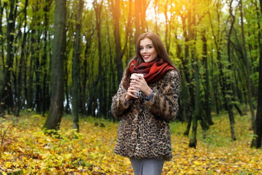 Autumn woman portrait smiling outdoors at the park