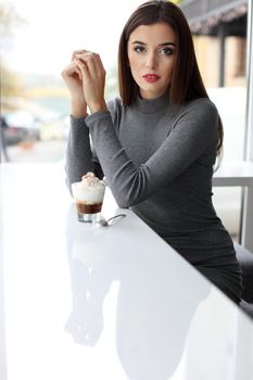 Girl eating chocolate desert brown with white cream