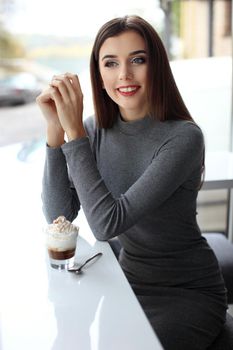 Girl eating chocolate desert brown with white cream