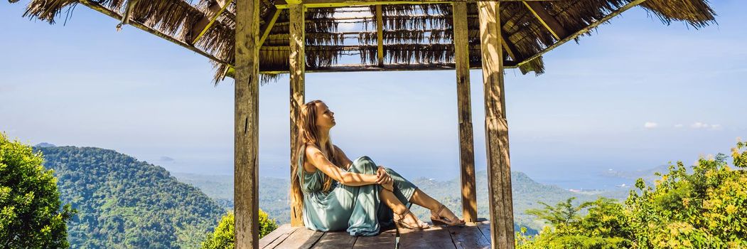 Young woman in traditional balinese gazebo. Bali island. BANNER, LONG FORMAT