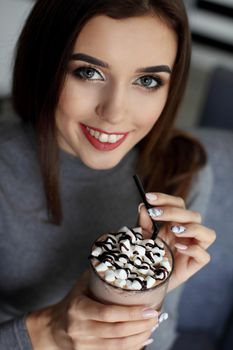 Girl eating chocolate desert brown with white cream