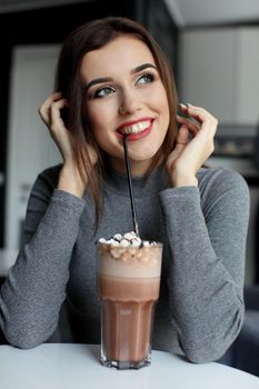 Girl eating chocolate desert brown with white cream