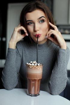 Girl eating chocolate desert brown with white cream