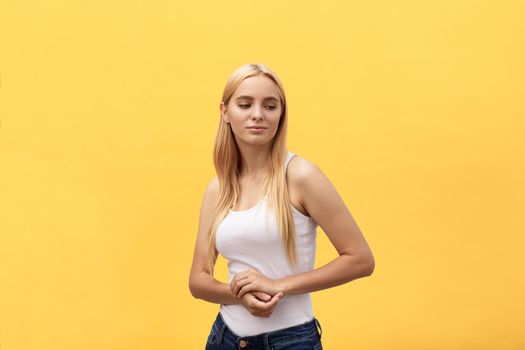 Portrait of happy beautiful young woman smiling looking at camera over yellow background