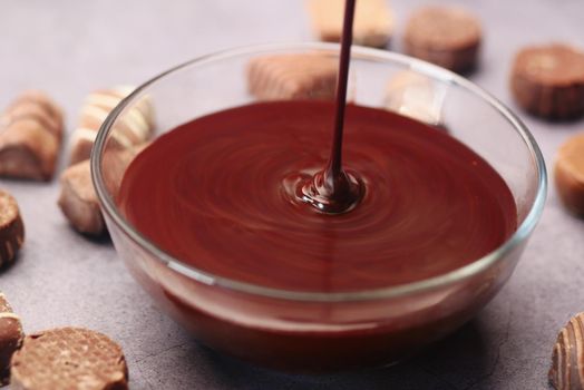 dark chocolate cream pouring in a bowl on table .