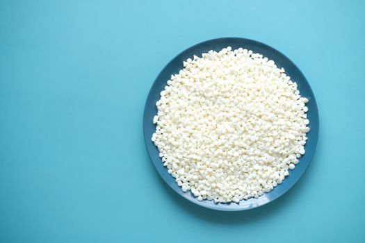 white Chocolate chips on a plate on table .