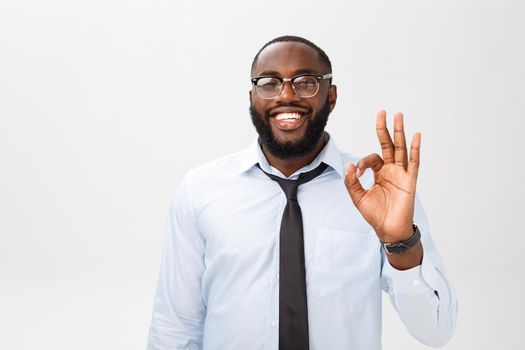 Portrait of african american business man smiling and showing okay sign. Body language concept.