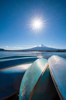 Sun star effect shot with Mountain Fuji and boats at Kawaguchiko lake Japan