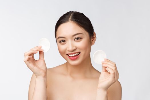 skin care woman removing face makeup with cotton swab pad - skin care concept. Facial closeup of beautiful mixed race model with perfect skin