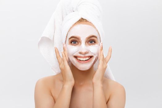 Beautiful woman with facial mask on white background.