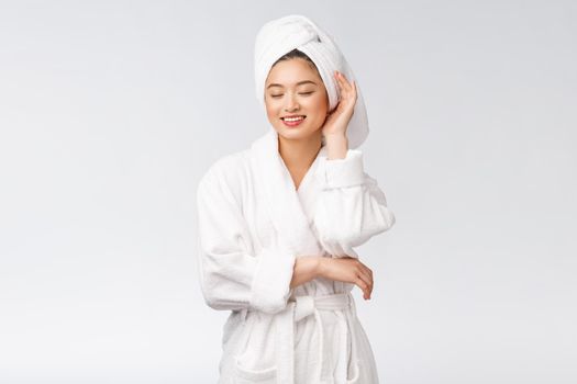 Portrait of a young happy asian lady in bathrobe.Isolated in white background