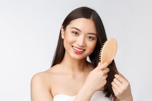 portrait of a beautiful young woman comb wonderful hair isolated on white background, asian beauty.