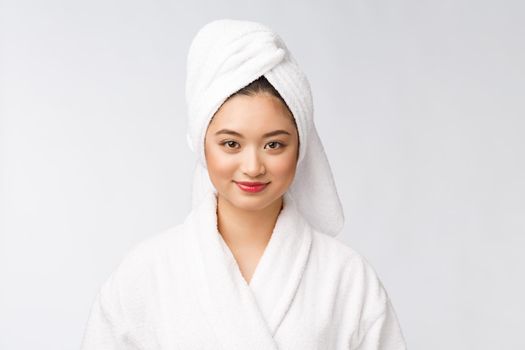 Portrait of a young happy asian lady in bathrobe.Isolated in white background