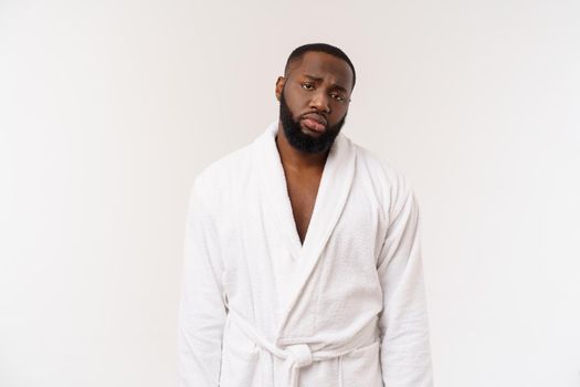 Young african american man wearing bathrobe over isolated white background thinking looking tired and bored with depression problems