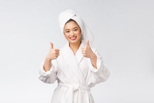 Beautiful asian woman perfect skin showing thumbs up isolated on white background