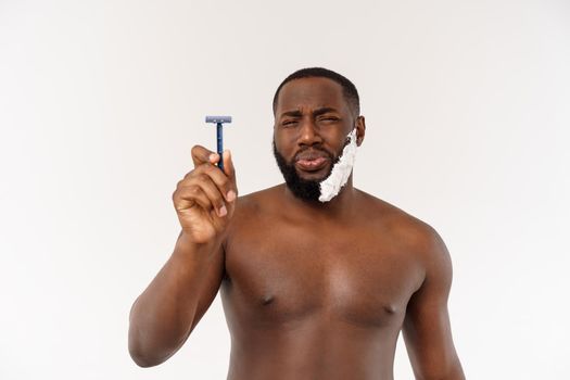 Young Afro American Man Shaving in Bathroom. Personal Morning Routine. Hygiene at Morning Concept