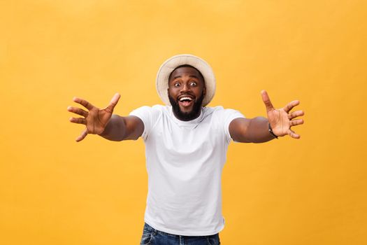 Come in my arms. Portrait of joyful friendly and happy handsome African American man with beard and short haircut, smiling broadly and pulling hands towards camera to give warm hug or cuddle