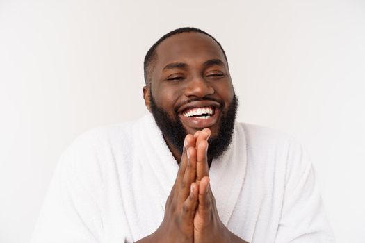 Black guy wearing a bathrobe pointing finger with surprise and happy emotion. Isolated over whtie background