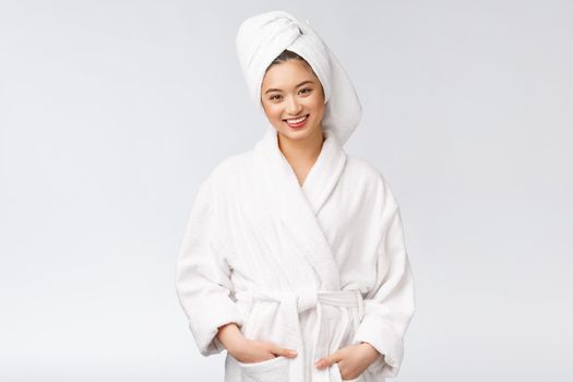 Portrait of a young happy asian lady in bathrobe.Isolated in white background