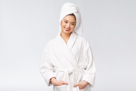 Portrait of a young happy asian lady in bathrobe.Isolated in white background