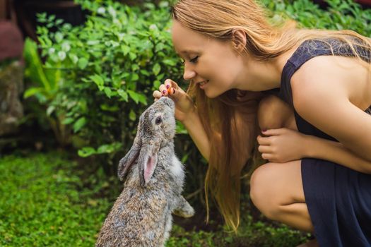 Woman holding a rabbit. Cosmetics test on rabbit animal. Cruelty free and stop animal abuse concept.