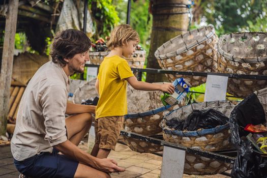 Dad and son, separate garbage collection. Teaching children to separate garbage collection.