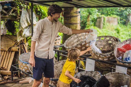 Dad and son, separate garbage collection. Teaching children to separate garbage collection.