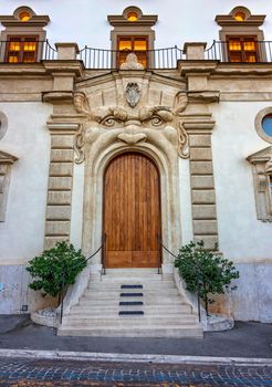 An old decorated vintage door in historical centre of Rome, Italy