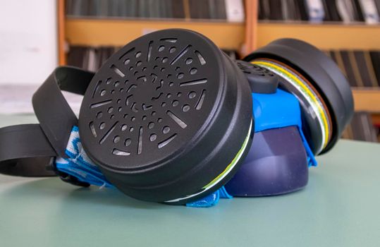 Respirator with interchangeable filter cartridges on the table