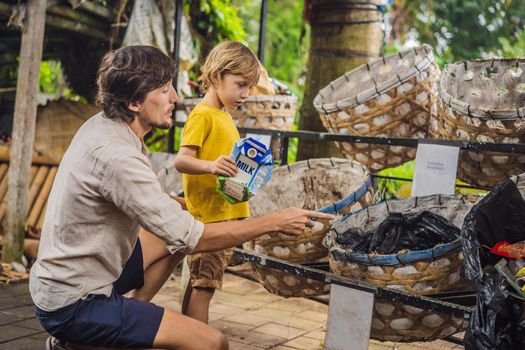 Dad and son, separate garbage collection. Teaching children to separate garbage collection.