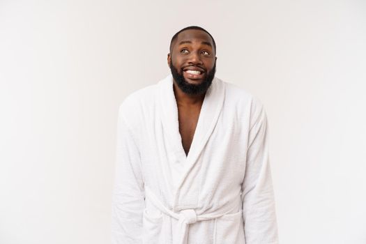 African American man wearing a bathrobe with surprise and happy emotion. Isolated over whtie background.