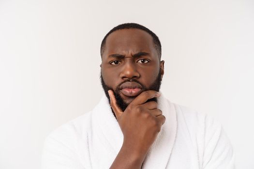 African American man wearing a bathrobe with surprise and happy emotion. Isolated over whtie background.