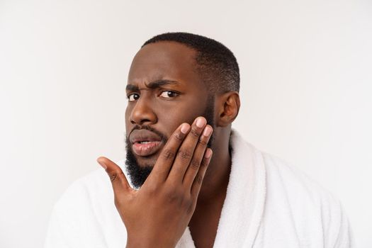 African American man wearing a bathrobe with surprise and happy emotion. Isolated over whtie background.