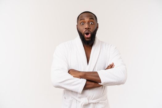 Black guy wearing a bathrobe pointing finger with surprise and happy emotion. Isolated over whtie background