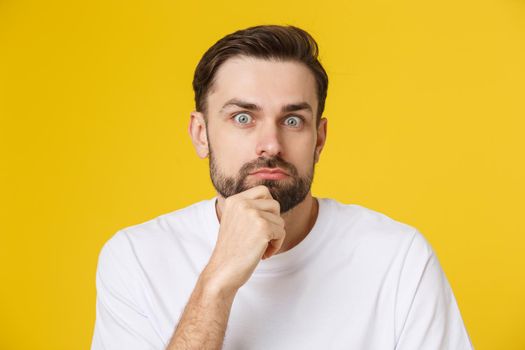 young bearded man looking amazed in to the camera.