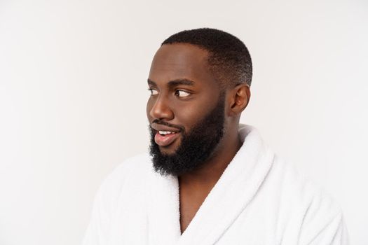 African American man wearing a bathrobe with surprise and happy emotion. Isolated over whtie background.