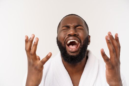 African American man wearing a bathrobe with surprise and happy emotion. Isolated over whtie background.